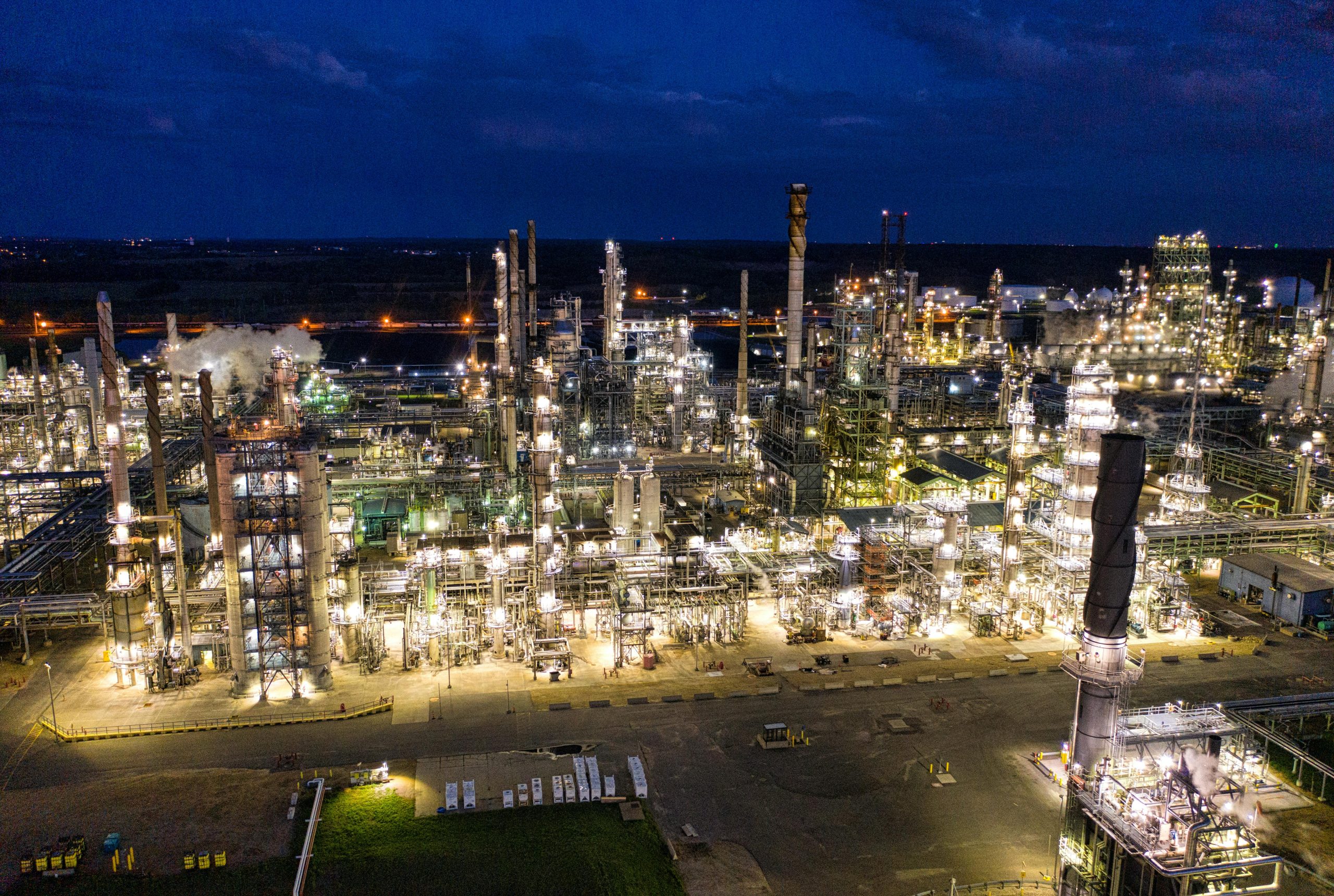 Aerial view of a brightly lit industrial refinery at night in Rosemount, MN.